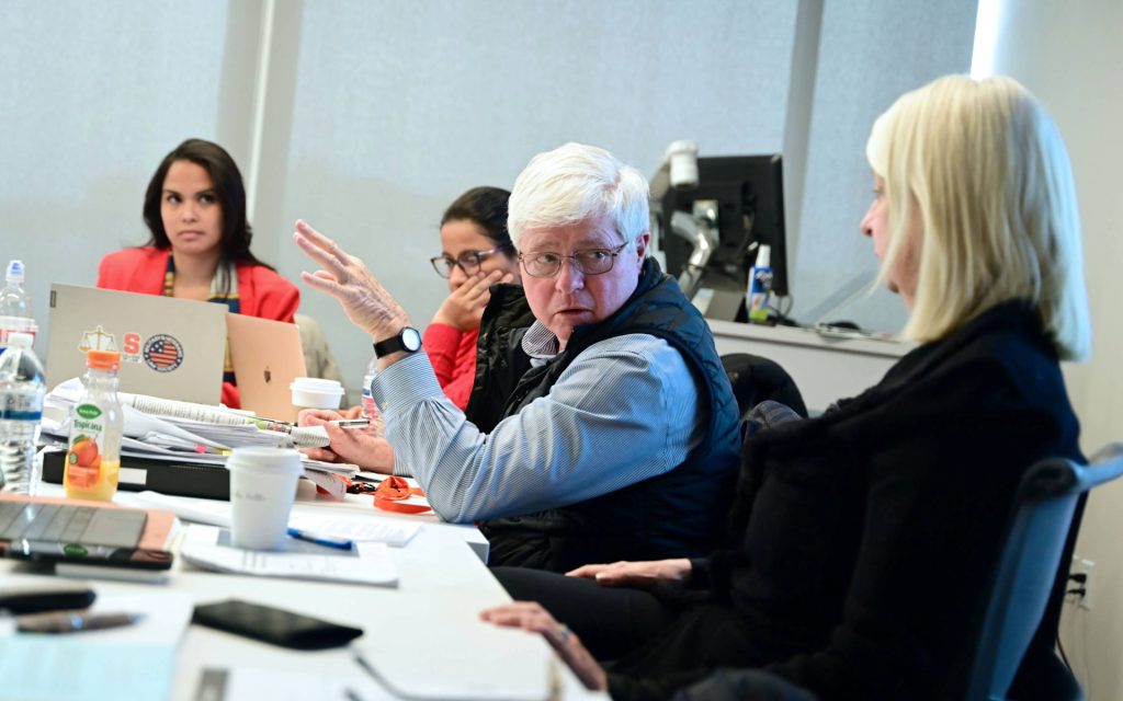 Randel Johnson sitting with Camile Olsen teaching a class. 
