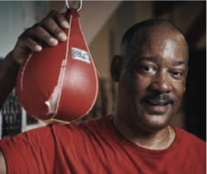 John Elmore with boxing punching bag. 
