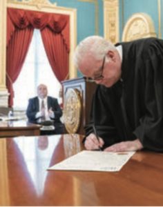  Justice Gerald Whalen, Appellate Division, Fourth Department signing a document. 