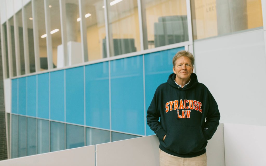 George Boehme L’26 standing in staircase in Dineen Hall. 
