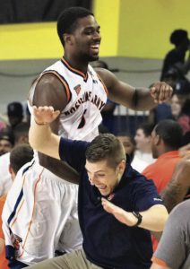 Kevin Belbey ’13, G’16, L’16 jumping with basketball player