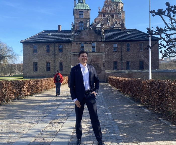 Austin Dewey standing in front of building in Copenhagen
