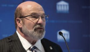 Photo of Scott Karson speaking at a podium.