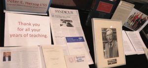 Photo of newspaper articles and books and pictures of Professor Emeritus Peter E. Herzog L’55. 