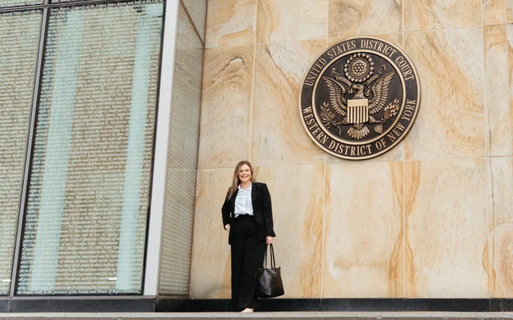 Carly standing in front of the Western District of New York, United States District Court sign