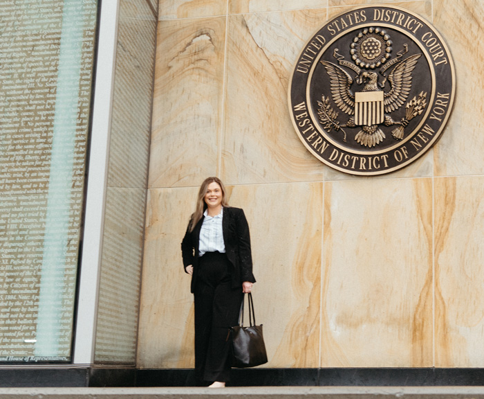 Carly standing in front of the Western District of New York, United States District Court sign