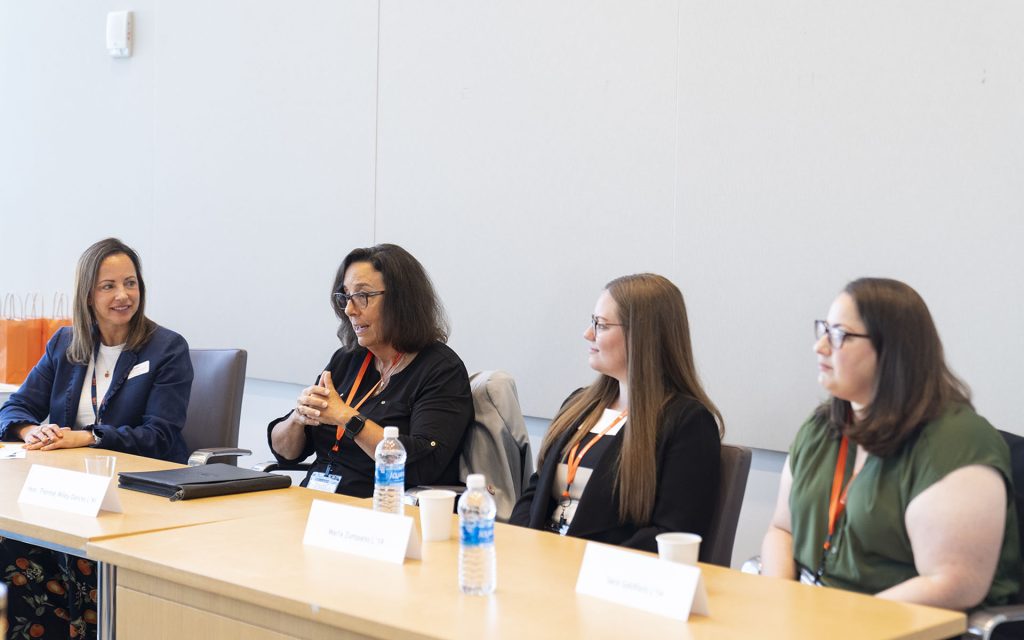 Hon. Thérèse Wiley Dancks L’91 sitting on a panel with 3 other people speaking.