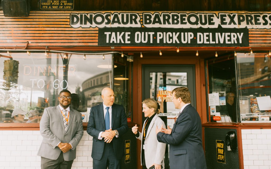 Students network with classmates in front of Dinosaur BBQ