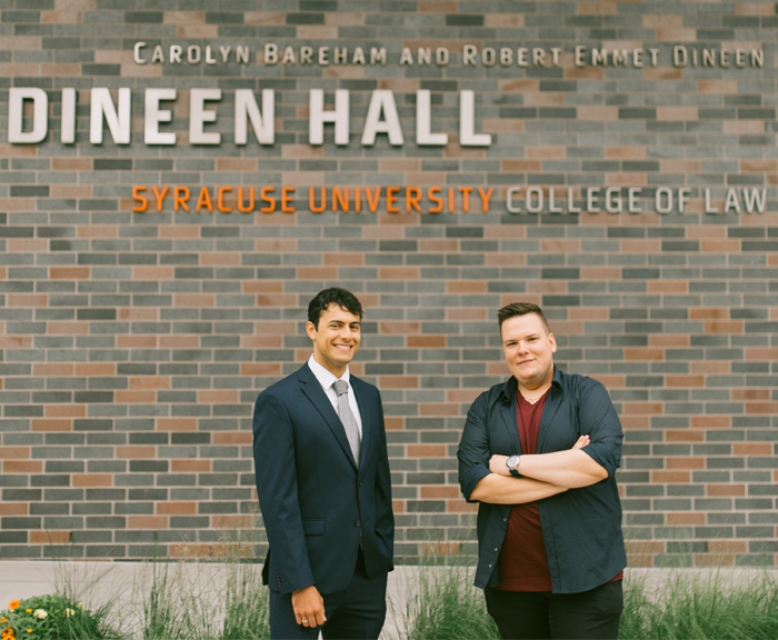 Two exchange students pause mid conversation in front of Dineen Hall to pose for the camera