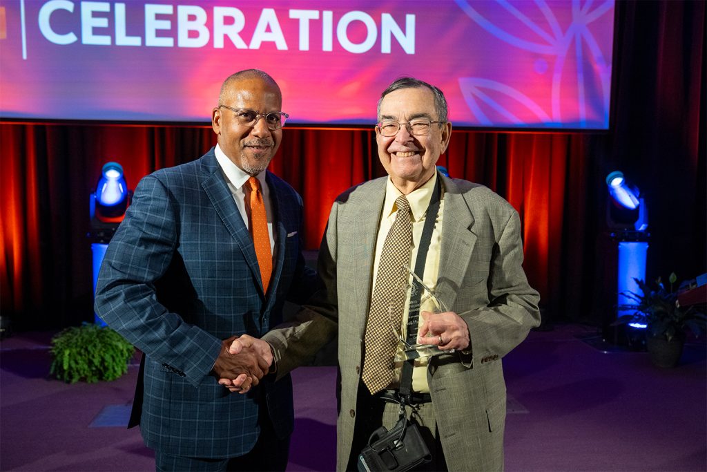 Dean Craig M. Boise presents J. Neil Huber L’68 with a Law Honors Award.