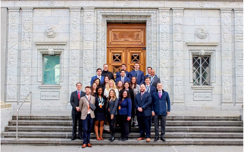 Group of law students in Switzerland outside of their residency location, standing on the steps