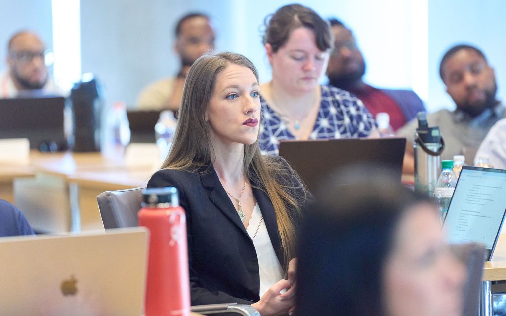 Students sitting in classroom with laptops