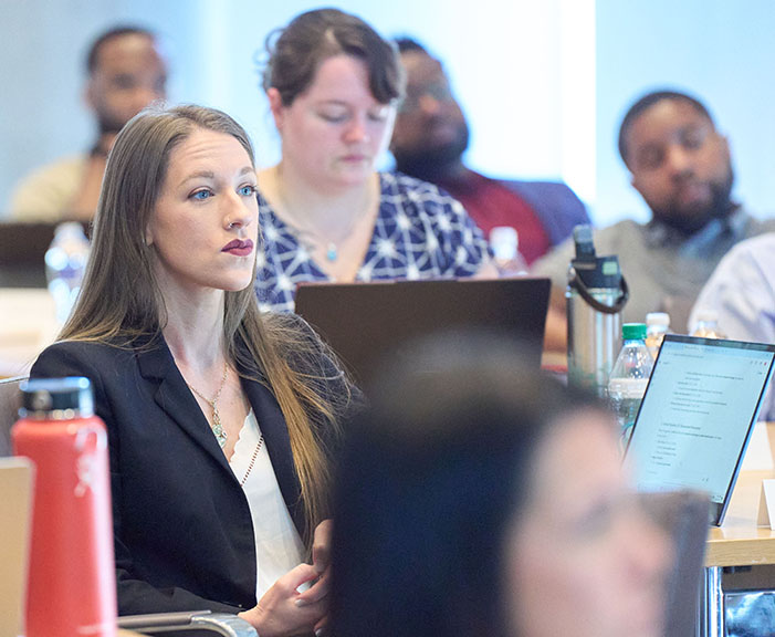 Students sitting in classroom with laptops
