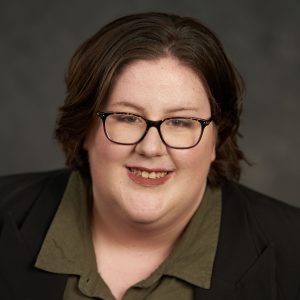 Headshot of Jude Unland in front of a gray background