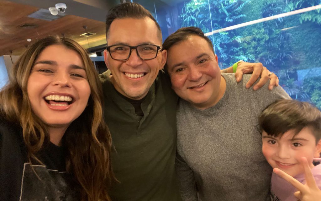Jimmy Gonzalez smiling with three members of his family at their reunion