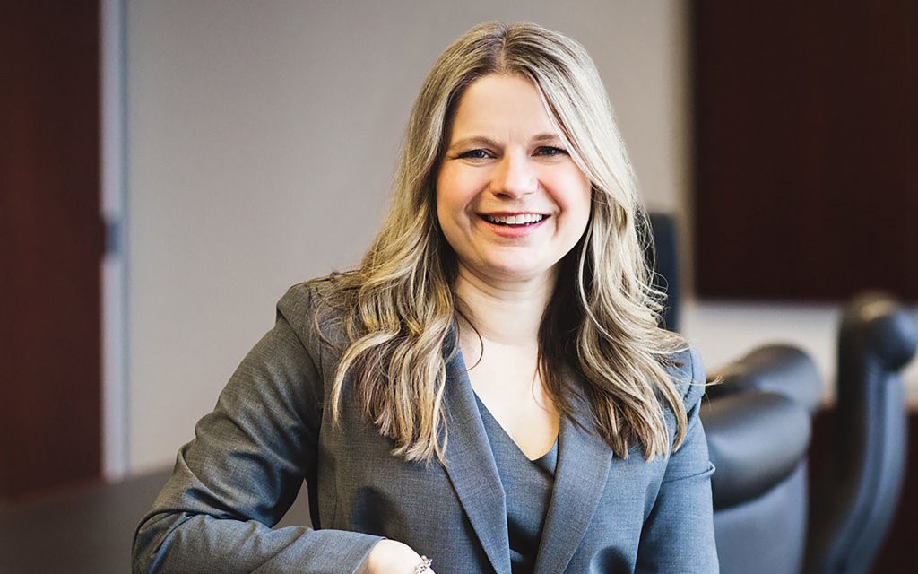 Kim Wolf Price Headshot wearing a gray suit