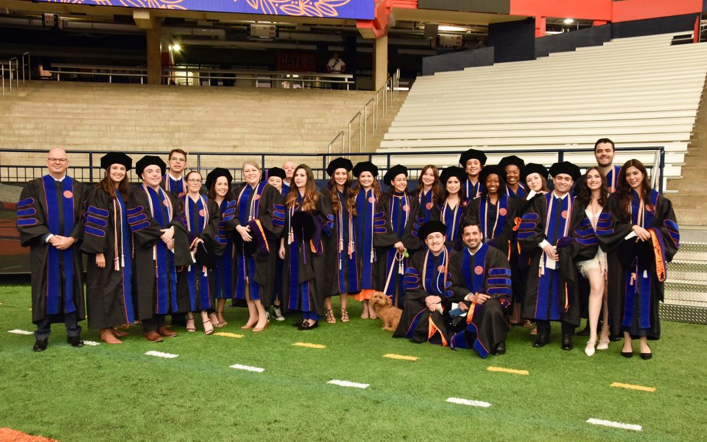 LL.M. students pose in their caps and gowns during commencement in 2024