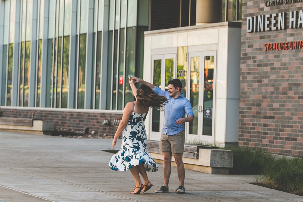 A couple dancing in front of Dineen Hall