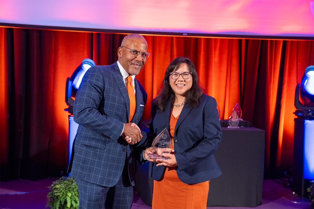 Dean Craig M. Boise present the Asian Pacific Islander (API) Legacy of Excellence Award to Tiffany H. Lee L’97, G’97. 