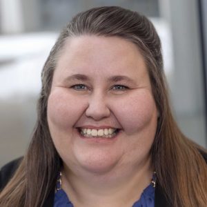 Headshot of Melissa Palzawicz in front of a gray background.