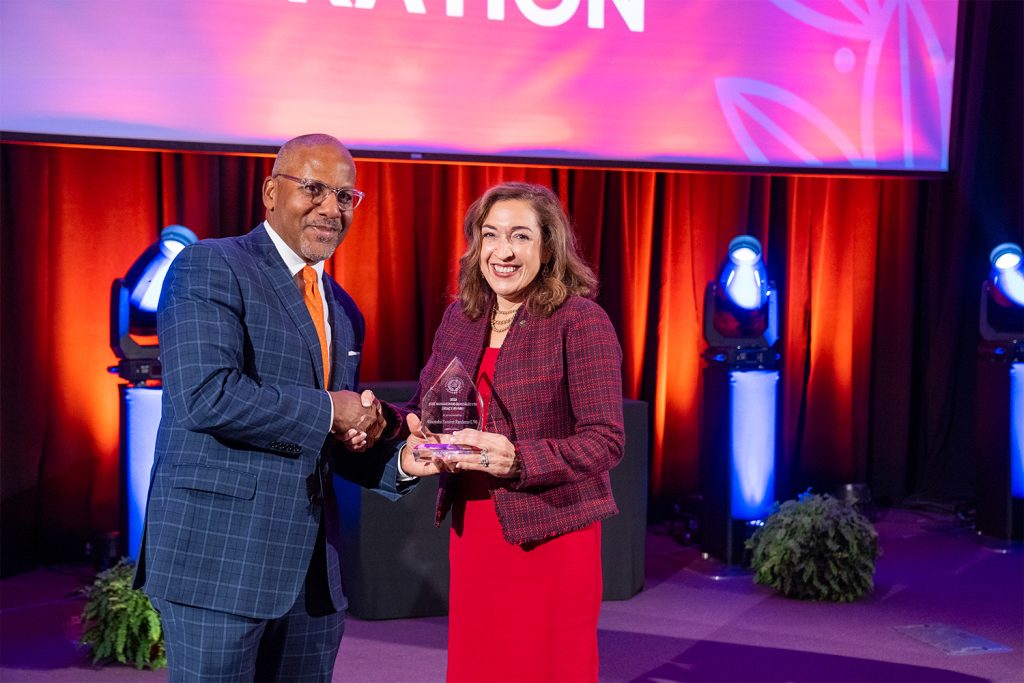 Dean Craig M. Boise presents the José Bahamonde-González L’92 Legacy Award to Alexandra Ramirez Randazzo L’96