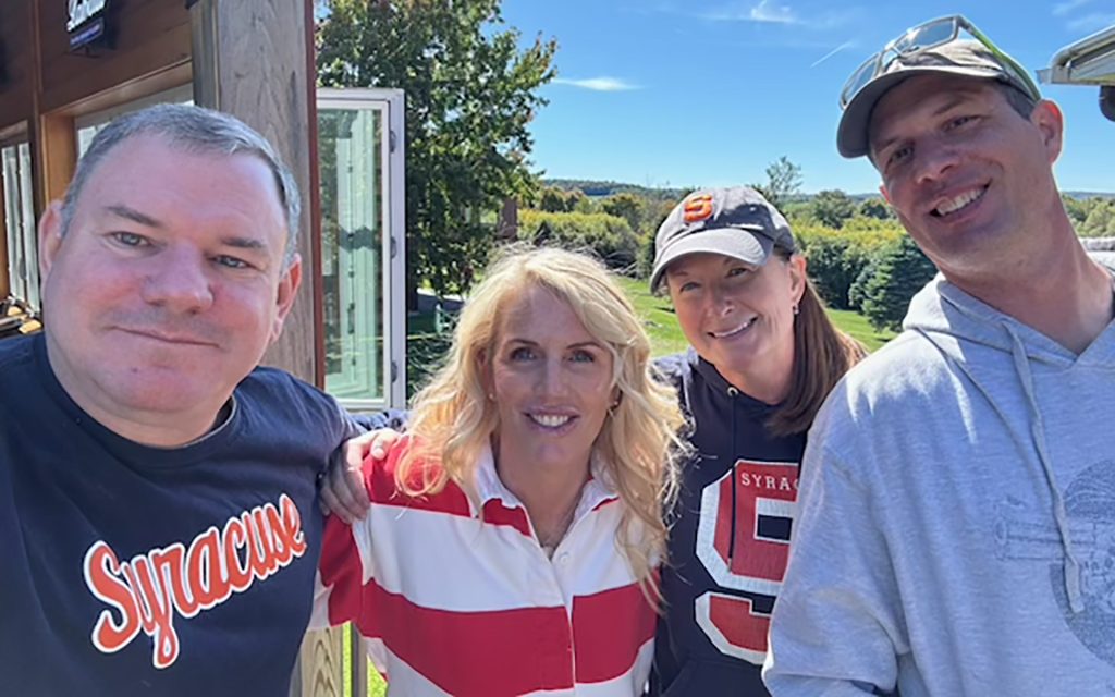 Randy Haimovici with Amy Zell L’00, Eileen Walsh L’00 and her husband, Jeremy Walsh in an outdoor photo