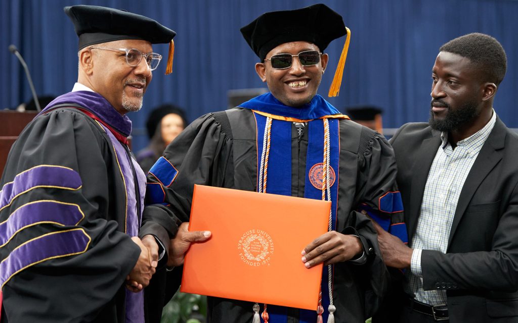 An S.D.J. graduate receives his diploma