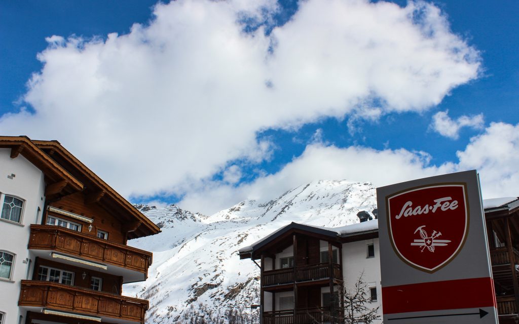 A sign reads Saas-Fee in a snowy village in the Alps