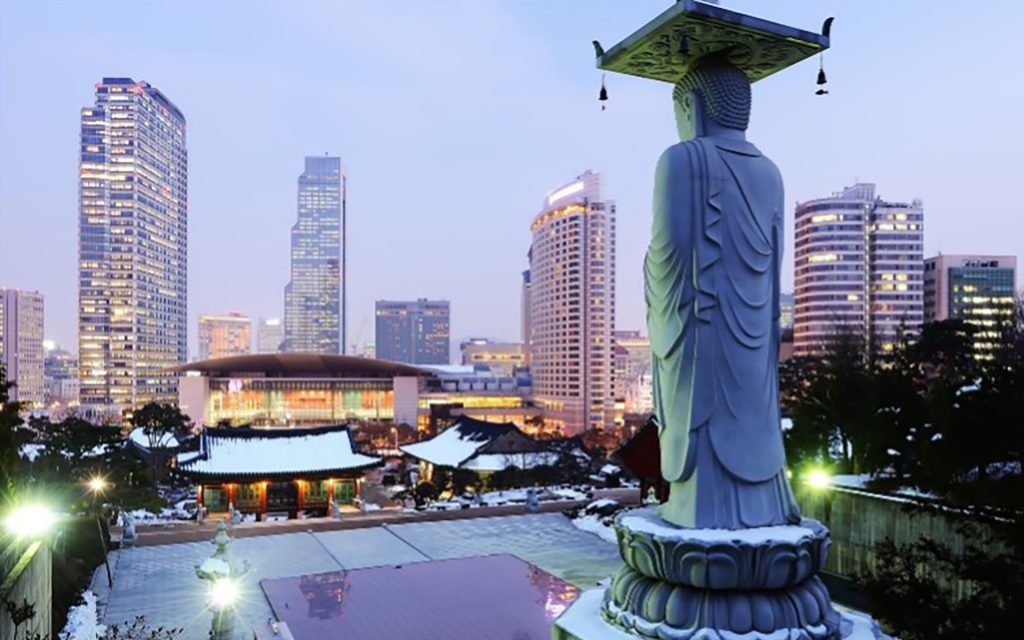 Seoul, South Korea, showing a statue in front of a pool and the city in the background