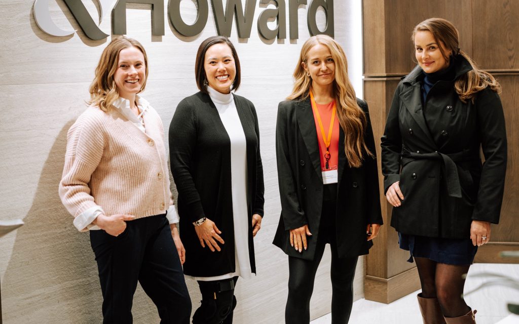 Amanda and classmates pose for a photo in front of the Sherman & Howard sign during a residency in Denver