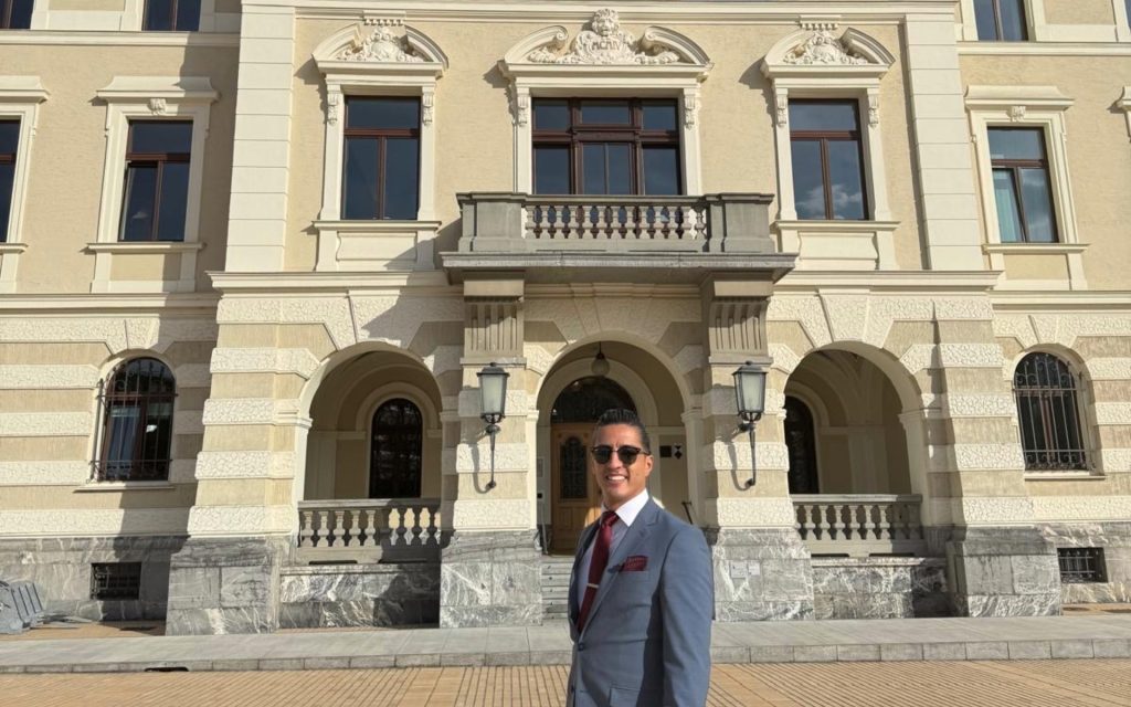 Syracuse University law student in front of building in Switzerland