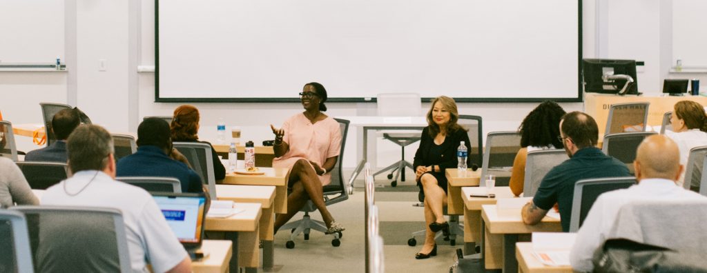 zabrina jenkins sitting in front of classroom full of students, speaking