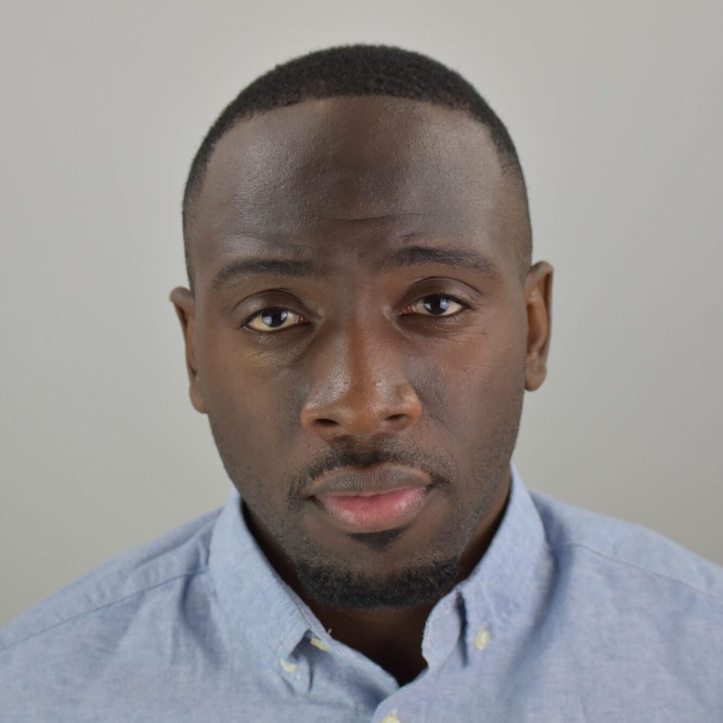 Headshot of Zebadayo in front of a gray wall