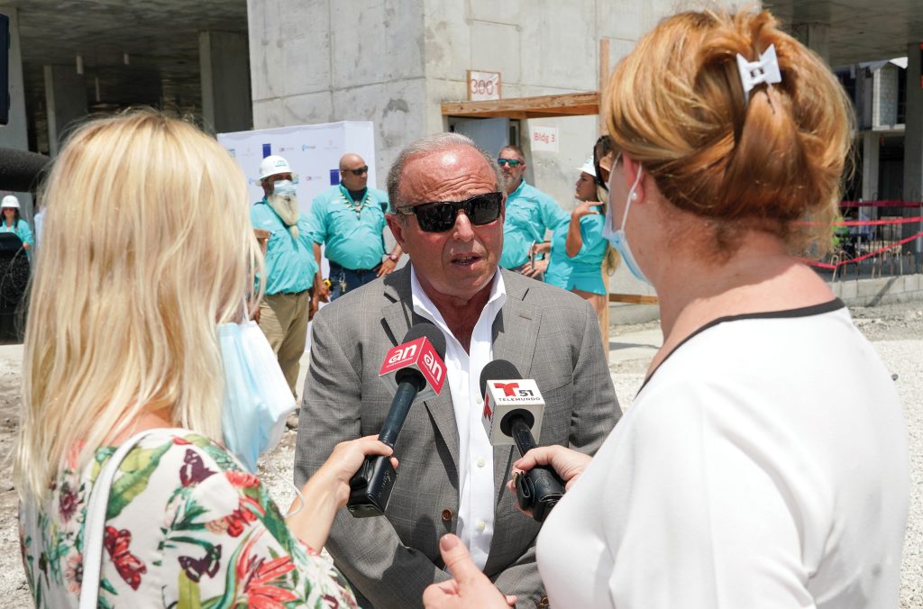 person being interviewed by two people with microphones